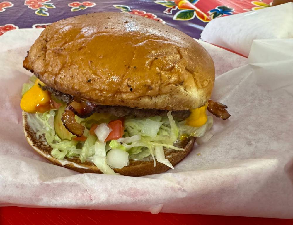 Bacon cheeseburger with fresh toppings at Diana's Burgers